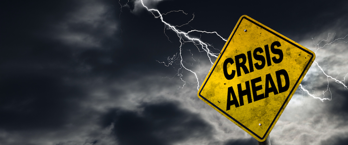 Crisis Ahead sign against a stormy background with lightning